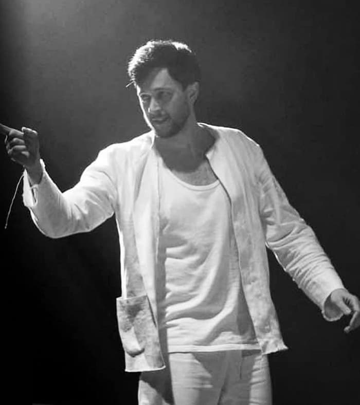 Mykhailo Yurchenko on stage in a theatre production, black and white photo